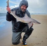 Sea Angler holding smoothhound in vass 220 winter waterproofs and waders 2